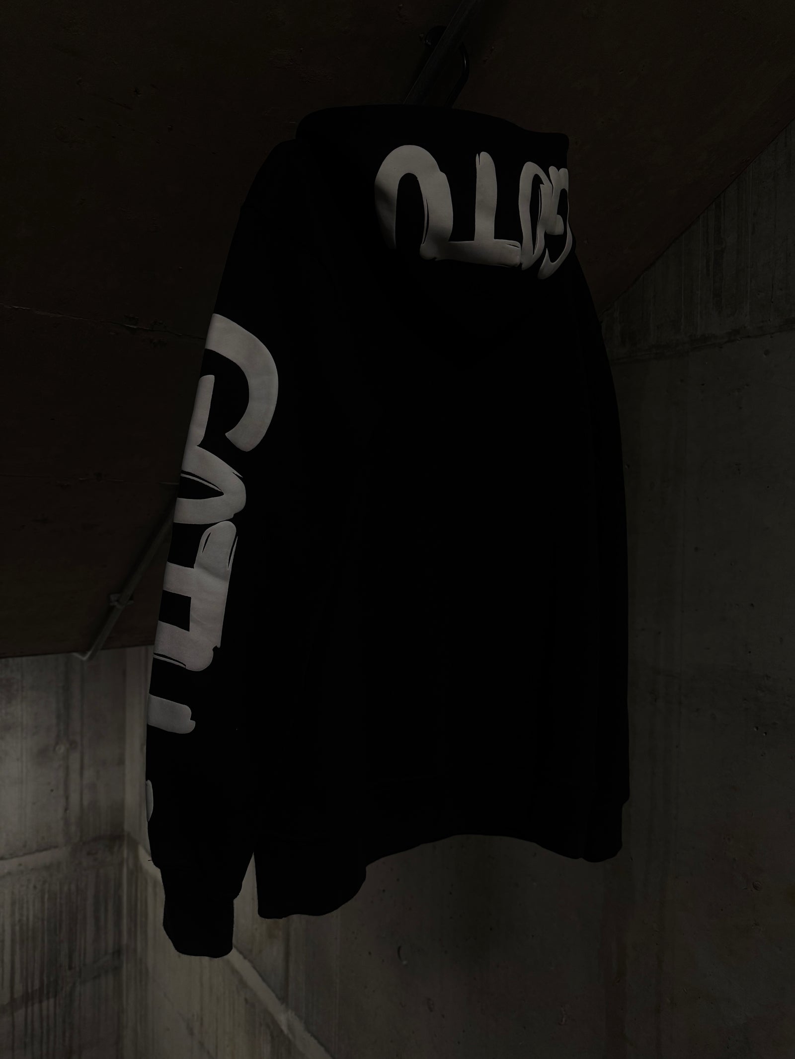 Angled view of the Initial State hoodie with oversized white Gotu graphics