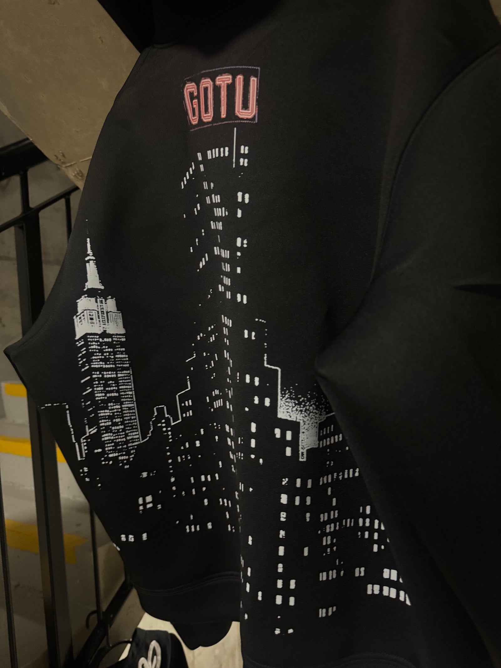Close-up of the Gotu city skyline graphic on the Built Beyond Comfort hoodie