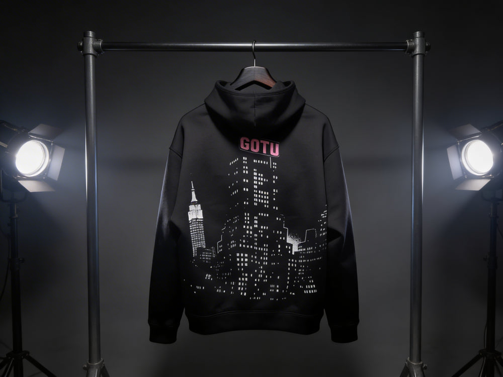 Back view of the black Built Beyond Comfort hoodie with Gotu city graphic
