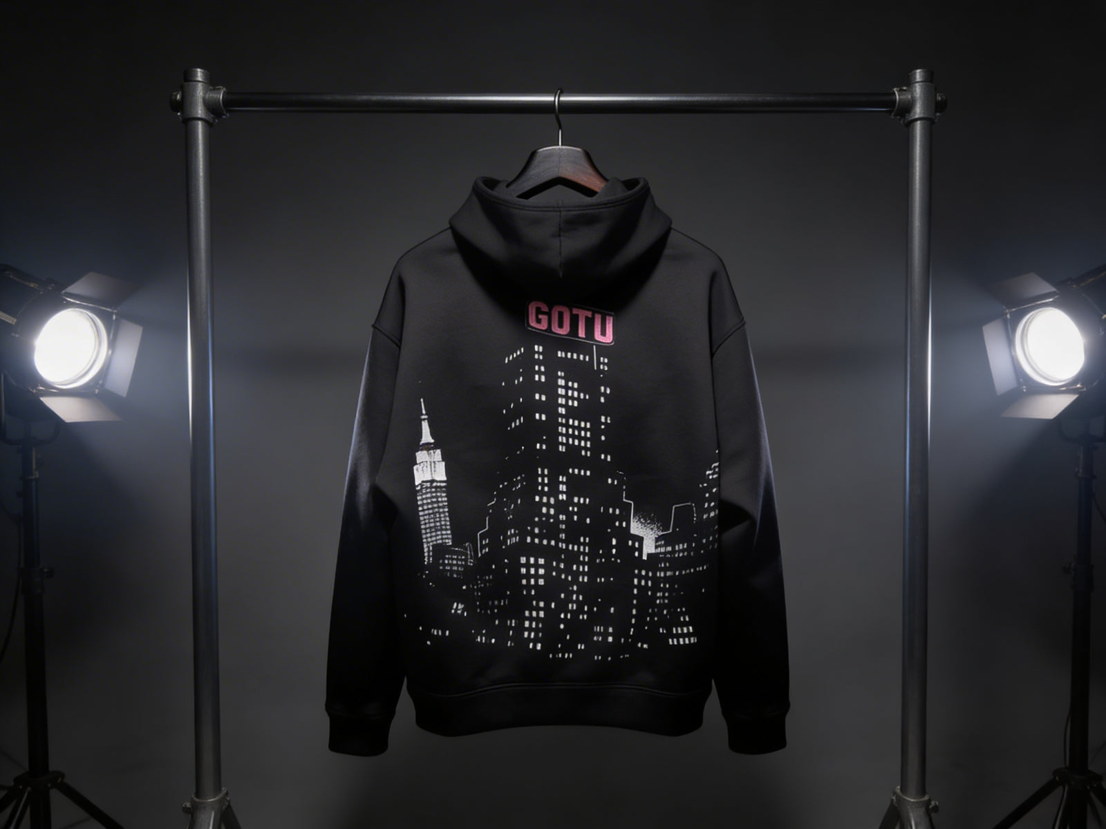 Back view of the black Built Beyond Comfort hoodie with Gotu city graphic