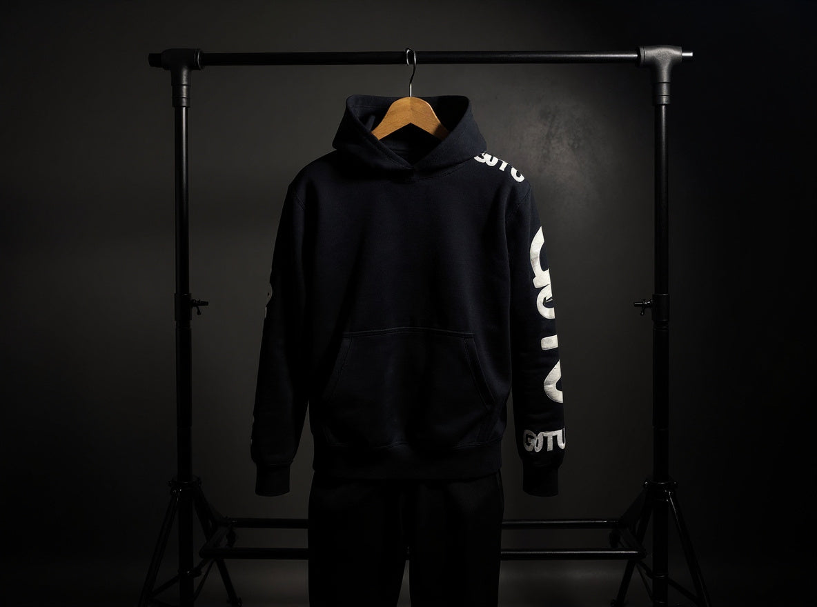 Front view of the black Initial State hoodie with white Gotu sleeve graphics