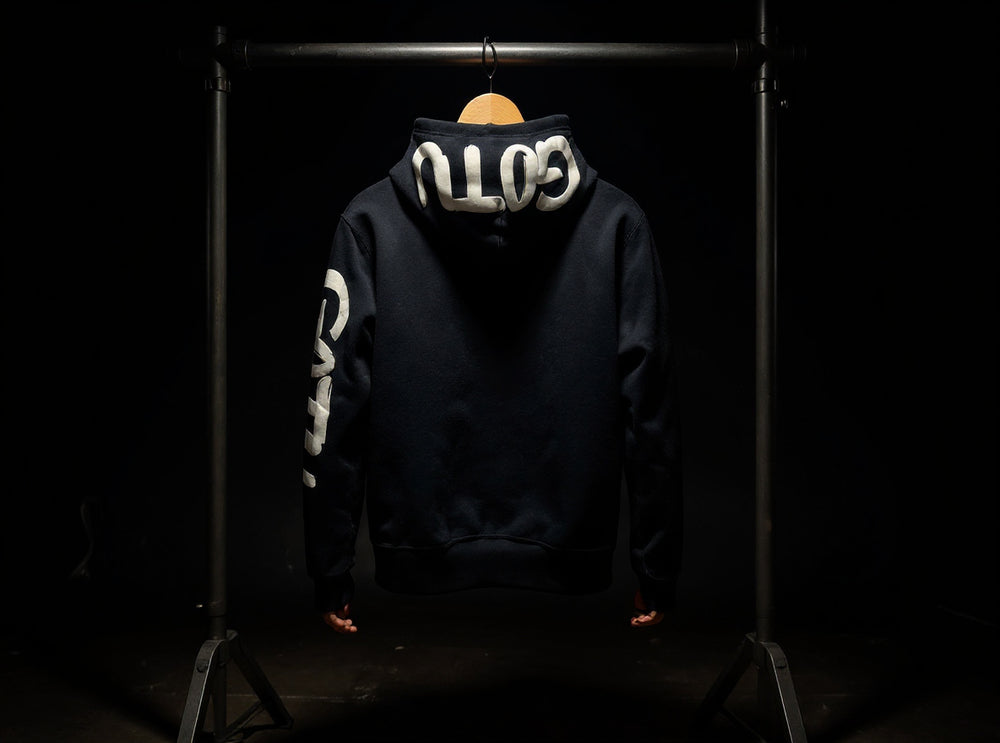 Back view of the black Initial State hoodie with white Gotu hood and sleeve lettering